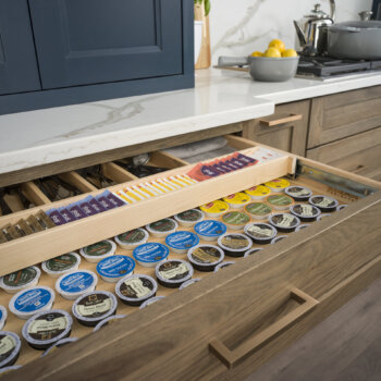 A Two-Tier Drawer with Drawer K-Cup Organizer from Dura Supreme Cabinetry. A Two-Tier Drawer can offer ample storage for an entire K-Cup collection and tea bags, as well as divided silverware storage.
